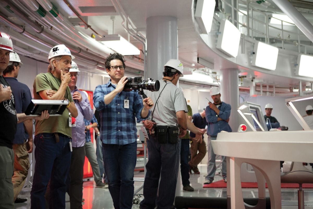 Mindel (wearing green) and Abrams (holding finder) set up a shot inside the National Ignition Facility at the Lawrence Livermore National Laboratory, which stood in for different sections of the Enterprise.