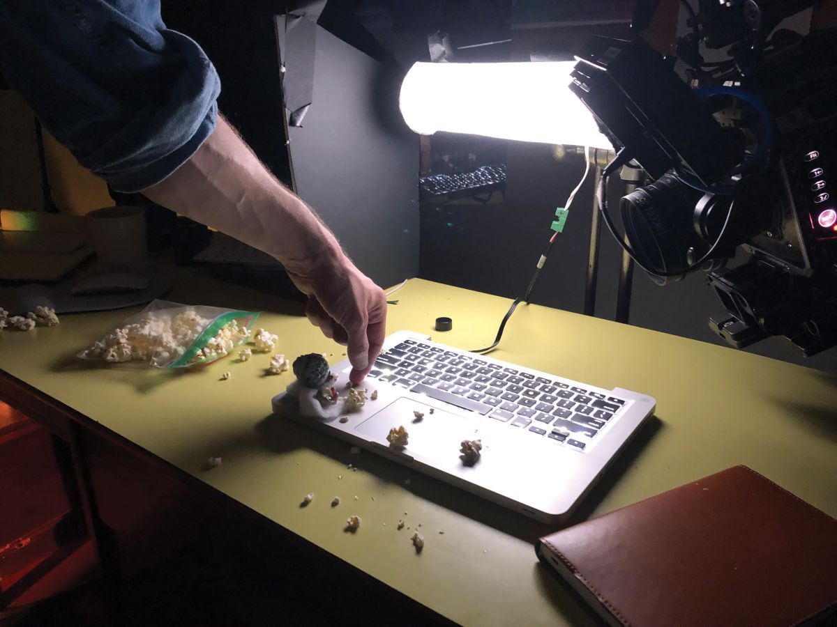 A Mac keyboard is illuminated for a shot of Marcel and Nana Connie eating popcorn and watching a show on the “big screen." (Photo by Bianca Kline)