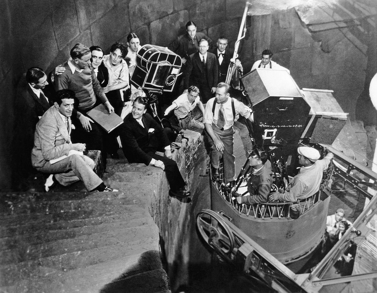 The Spanish-language company on the Carfax Abbey set. In front of camera from left are visitor Tod Browning, B. Fernandez Cue, George Melford, Carlos Villarias and Barry Norton. Riding the Broadway crane are George Robinson, ASC and his camera crew. The man wearing a string tie is Eduardo Arozamena.