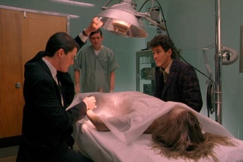 FBI Agent Dale Cooper (Kyle MacLachlan, left) and Sheriff Harry S. Truman (Michael Ontkean) prepare to examine Laura Palmer’s body.