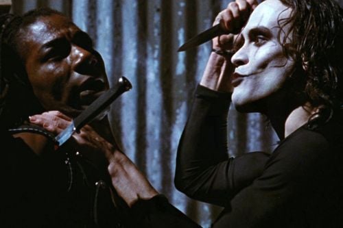 The Crow (Brandon Lee) confronts Tin Tin (Laurence Mason), one of the criminals who attacked him and his fiancée.