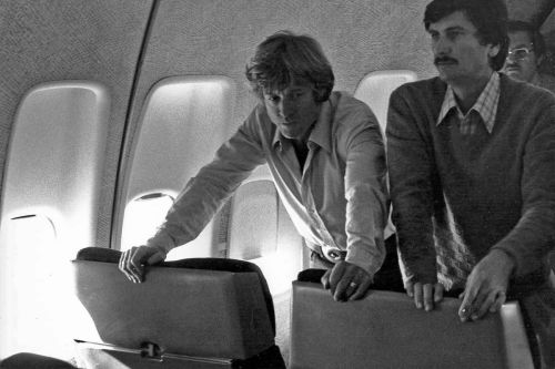 Director Robert Redford and cinematographer John Bailey prepare a scene on an airplane.