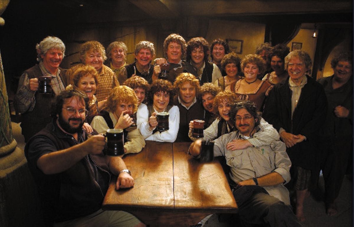 Director Peter Jackson (left front, gripping a hard-earned stein of ale) and Lesnie (right front) celebrate their cinematic achievements with a roomful of happy Hobbits.