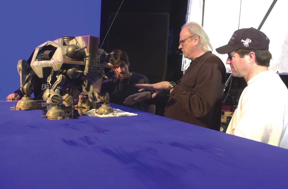 On the 2002 prequel Star Wars: Episode II — Attack of the Clones, Muren (center), pyro-effects supervisor Geoff Heron (left) and camera operator Vance Piper inspect the articulation of a six-legged AT-TE Walker model.