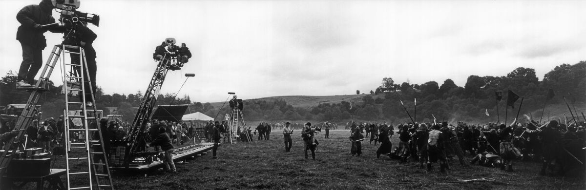 Using multiple camera setups, Toll prepares to shoot a scene depicting the Battle of Falkirk during the filming of the period epic Braveheart (1995), directed by and starring Mel Gibson. His work earned the cinematographer his second consecutive Oscar and the ASC Award.