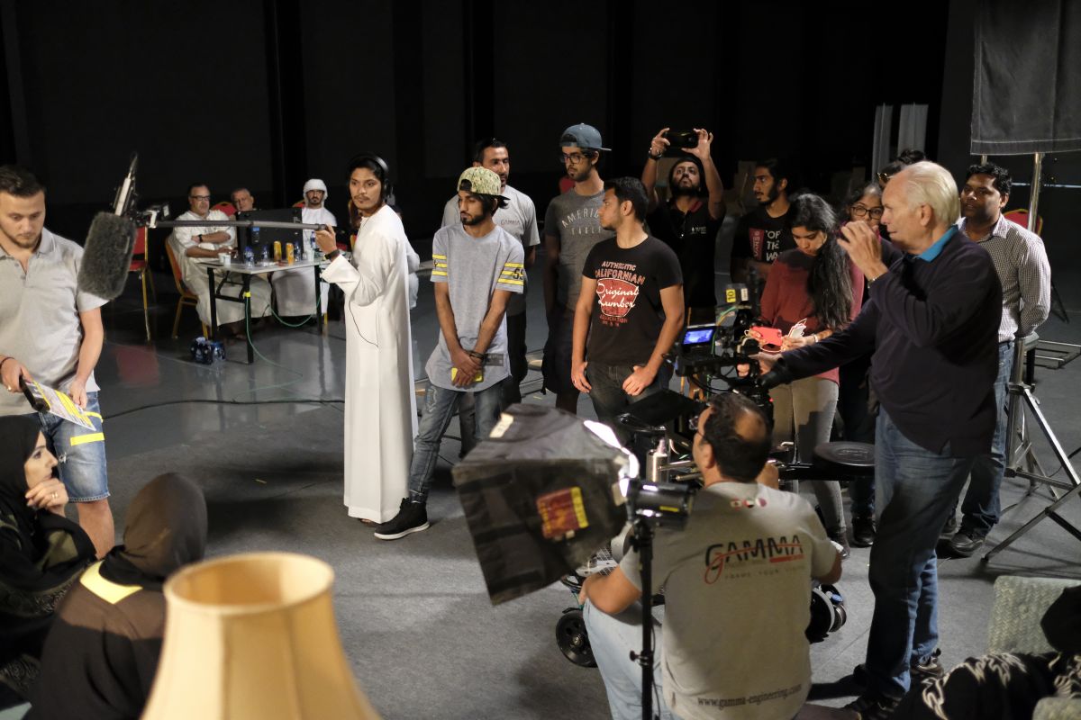 Shaw leads his class in constructing a scene. “One of the students in class had written a script and we built a set — much like what is done for the ASC Master Class sessions — and blocked out the action with five actors, lit it with the students, and set the shots,” he describes. “The key thing is that we got the class out of their seats and in the set. You learn best by doing.” In the background are key event organizers, standing in as “executive producers.”