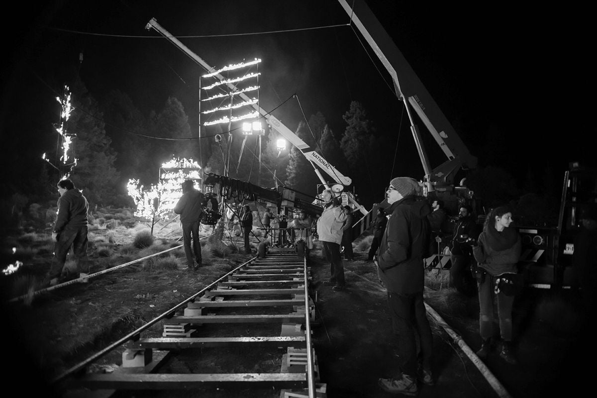 Inspectors restricted them from using fire in the background near real trees, so instead the crew placed a series of LED panels on a slight incline on the ground, which projected video of fire onto the trees for a flickering effect.  A similar panel suspended from a crane provided backlight on the actors. Four 18Ks were placed in the far distance to give a very dim light level to the forest in the deep background.