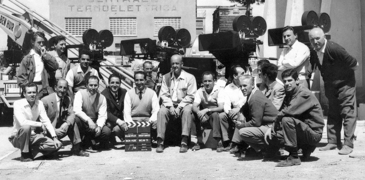 At center, cinematographer Robert Surtees, ASC is surrounded by his camera team on the Cinecitta Studio lot in Rome. Ultra Panavision optics create a mild 1.25 anamorphic squeeze of the 2.2:1 image area, resulting in an ultra-wide 2.76:1 aspect ratio on the screen.