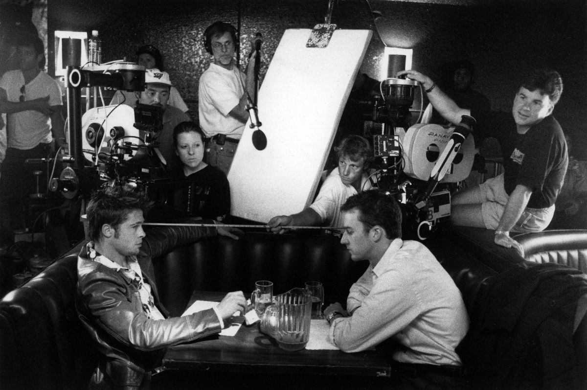 Cronenweth (wearing cap, just behind the camera on left) and his crew set up double coverage for a conversation scene between Tyler Durden (Brad Pitt) and the film's nameless narrator (Edward Norton).