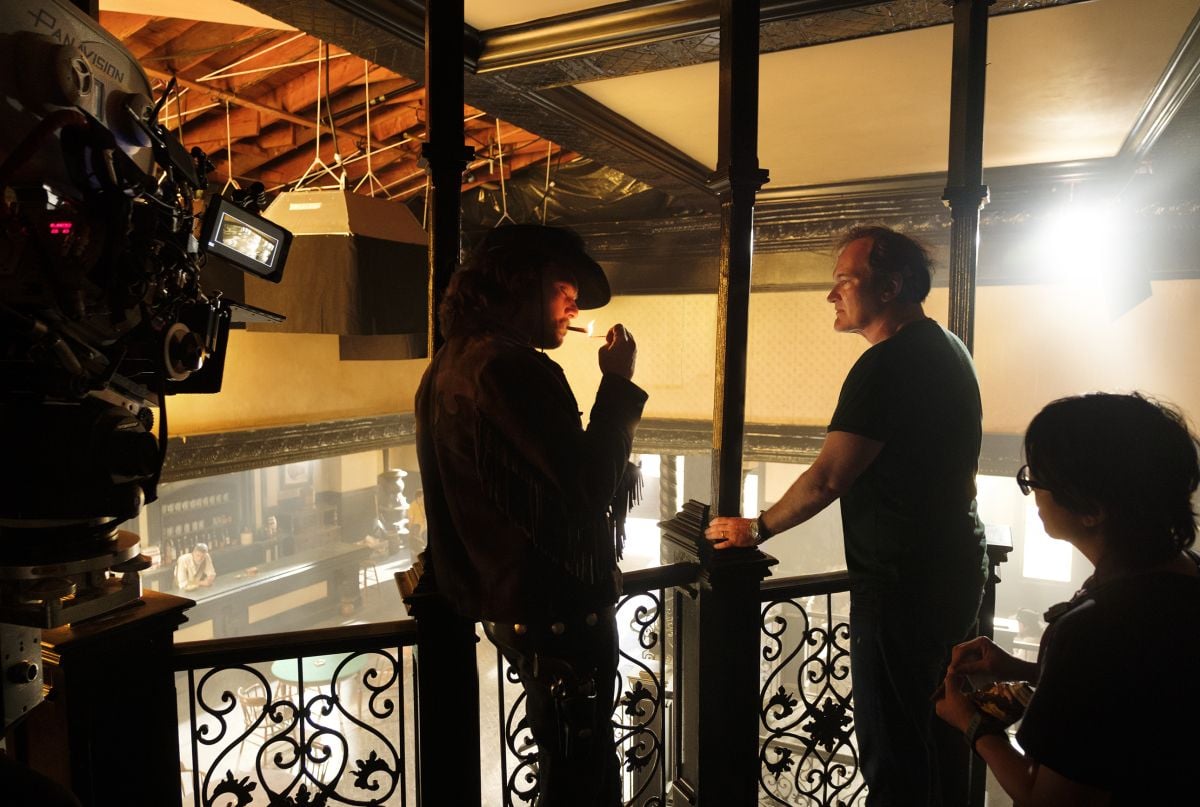 DiCaprio and Tarantino at work in the Western set. Kincaid notes that a "period-correct Mole 'chicken-coop' light" can be seen hanging in the background.