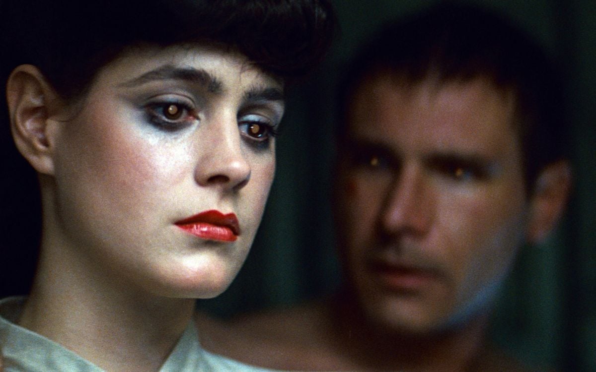 In Blade Runner (1982), Rick Deckard (Harrison Ford) finds himself drawn to the mysterious replicant Rachael (Sean Young). One of the identifying characteristics of replicants is a strange glowing quality of the eyes. Cinematographer Jordan Cronenweth, ASC revealed his technique in American Cinematographer: “We'd use a two-way mirror ― 50% transmission, 50% transmission, 50% reflection ― placed in front of the [camera] lens at a 45 degree angle. Then we'd project a light into the mirror so that it would be reflected into the eyes of the subject along the optical axis of the lens. Sometimes we'd use very subtle colored gels to add color to the eyes.”