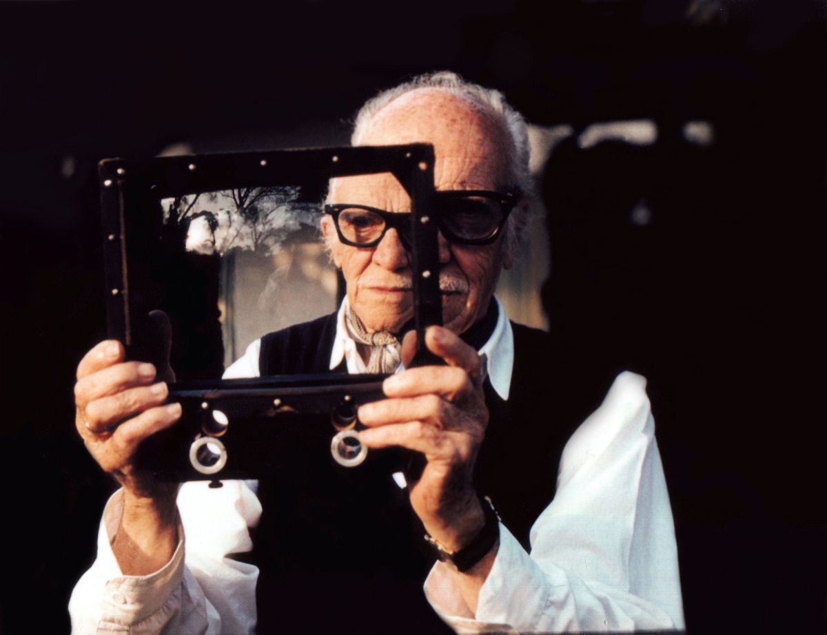 Figueroa photographed in his home in 1991. He's holding a gift from director John Ford: a diminishing glass used to convert a 25mm lens to 20mm for shooting landscapes. (Photo by the author, Tom Dey)