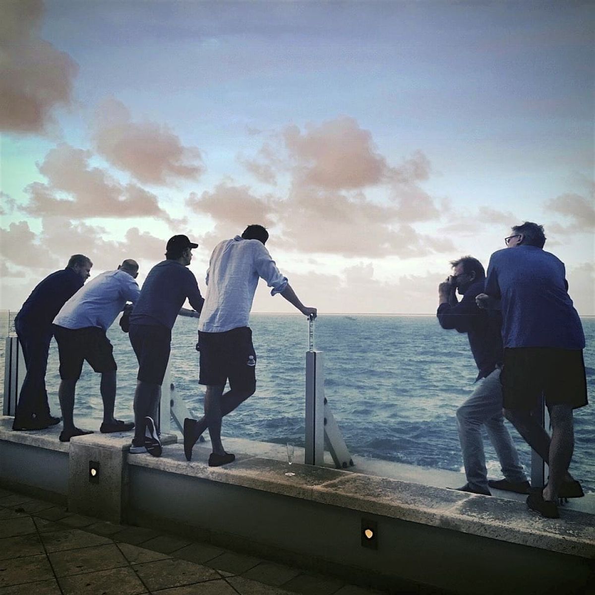 Director Nick Hamm (far right) looks on as cinematographer Karl Walter Lindenlaub, ASC, BVK (second from right) grabs a photograph of the cast the night before the production had to evacuate from Puerto Rico in advance of Hurricane Maria.