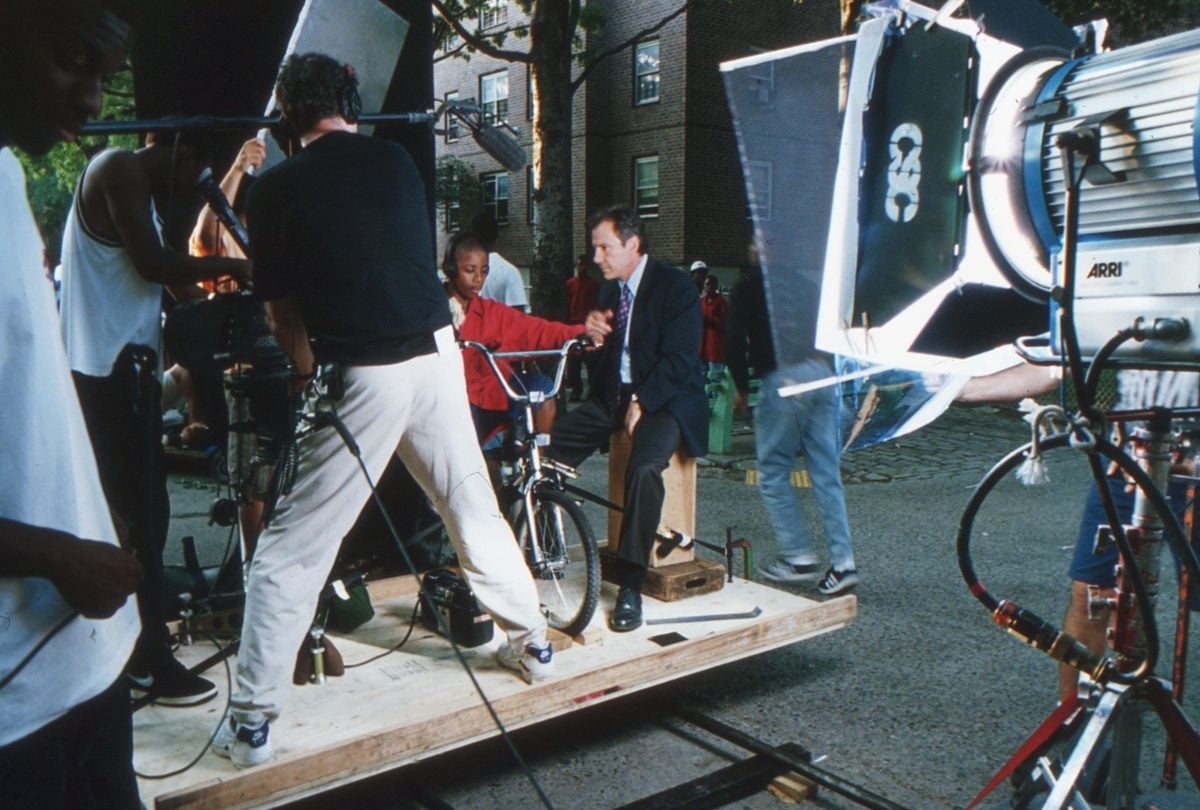 To create a surrealistic flashback scene in which Detective Klein floats along behind a boy's bicycle, the filmmakers placed the camera and the actors on a plywood sled. Mounted on lengths of black pipe, the sled was pushed past the location background to create the otherworldly effect seen in the finished frame. (Seen below.)