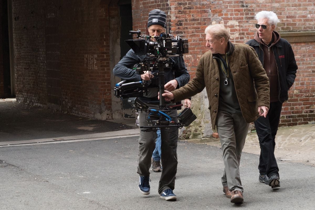 As director Jim Jarmusch walks along with (right), Elmes works out a shot with Steadicam operator Mark Schmidt during the filming of the poetic drama Paterson (2016).
