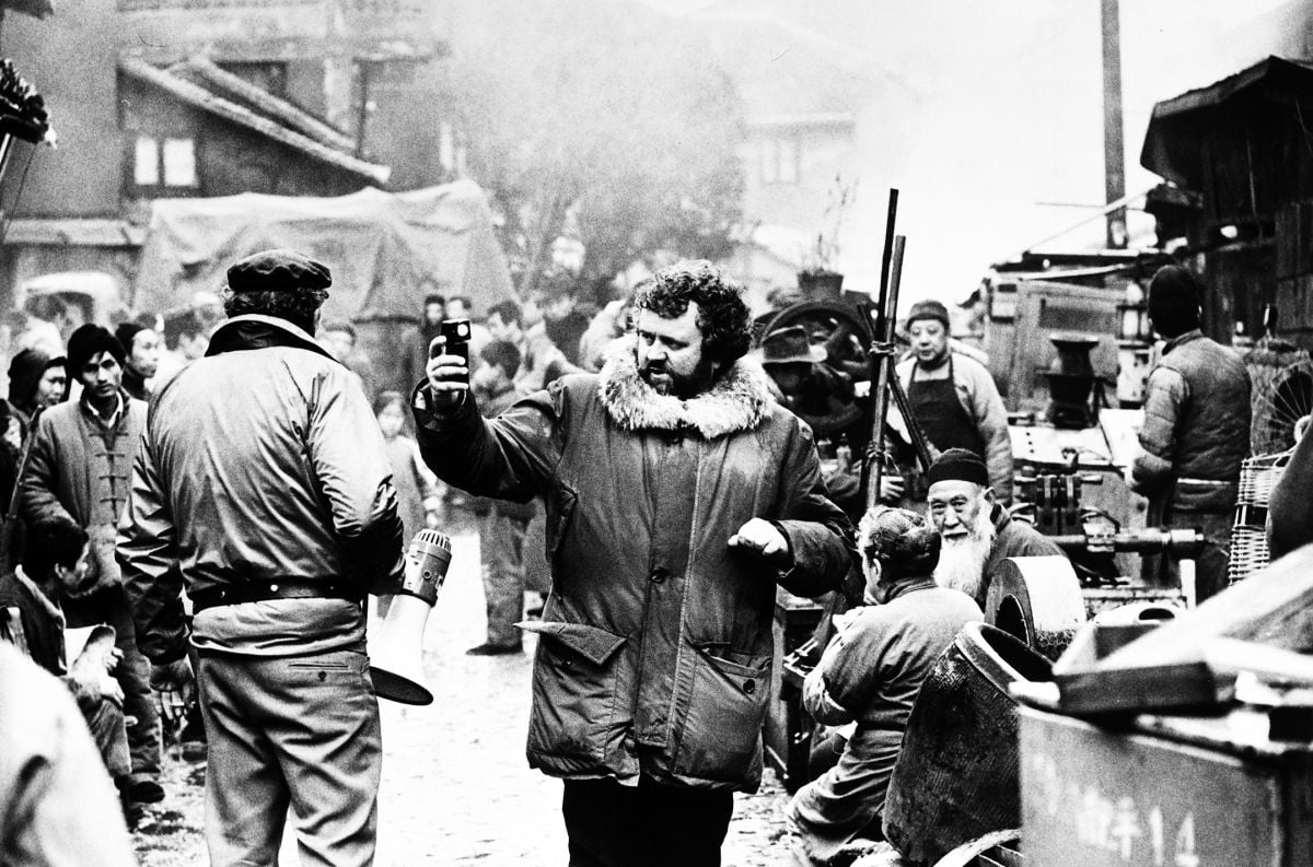 On location in China, Daviau check his light during the production of Empire of the Sun (1987).