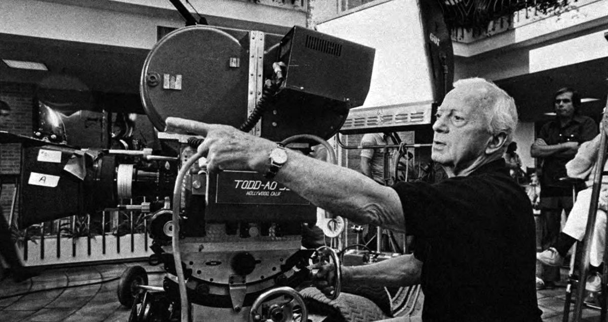 Director of photography Ernest Laszlo, ASC checks a setup on Dallas location. On top of the Todd-AO camera can be seen the monitor of the electronic viewing system used on the production. It was helpful to the director and producer, enabling them to view “instant dailies” via playback on the set.