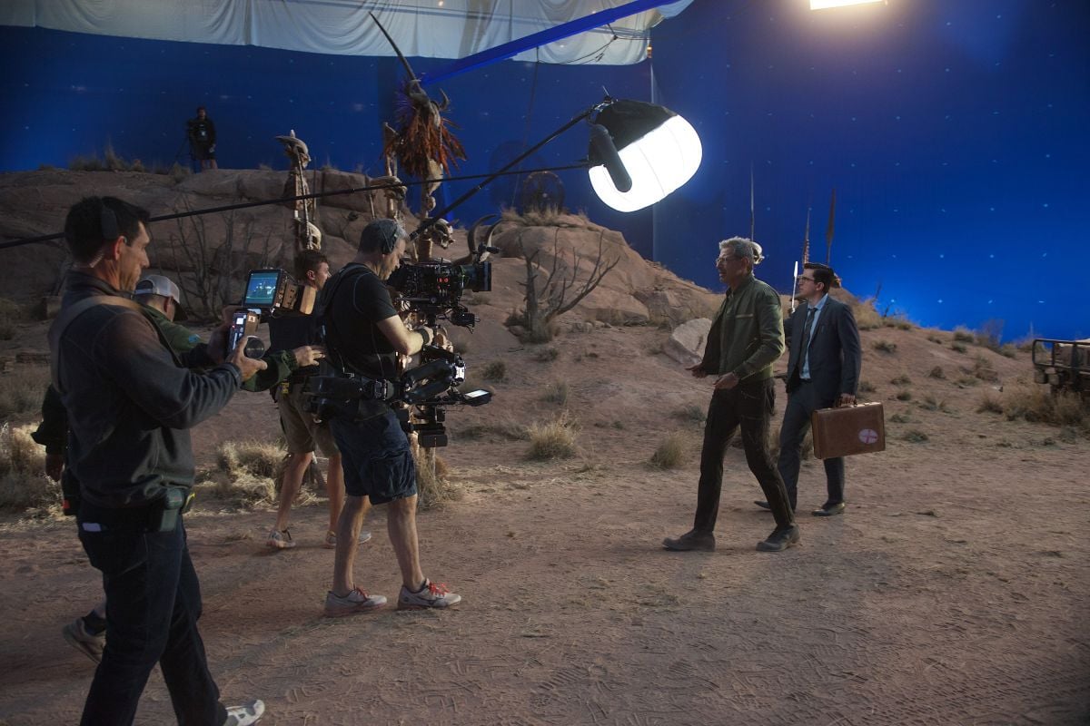 Cast and crew work on a stage-bound desert set surrounded by bluescreen, with a day-blue muslin stretched overhead.