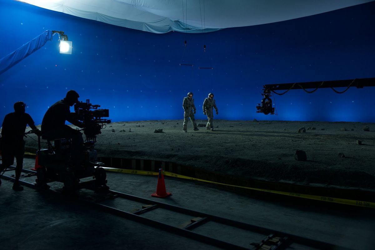The crew shoots a scene in which Levinson and Morrison walk on the moon.