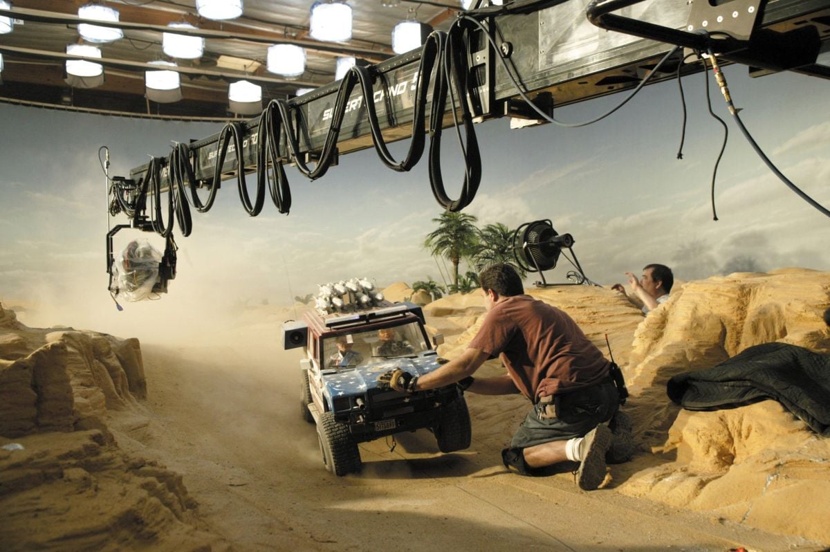 A Super Technocrane is used to track a miniature all-terrain vehicle through a  desert set. “On all of our ‘exteriors,’ we had an ambience rigged for the sets with rows of space lights in the perms,” Pope notes. “The day exteriors were easier because we could use some bigger lights, but I still tried to light scenes in the same way I would a real-sized set, in order to make them look real. I wanted people to forget that they were looking at 2-foot-tall puppets.”