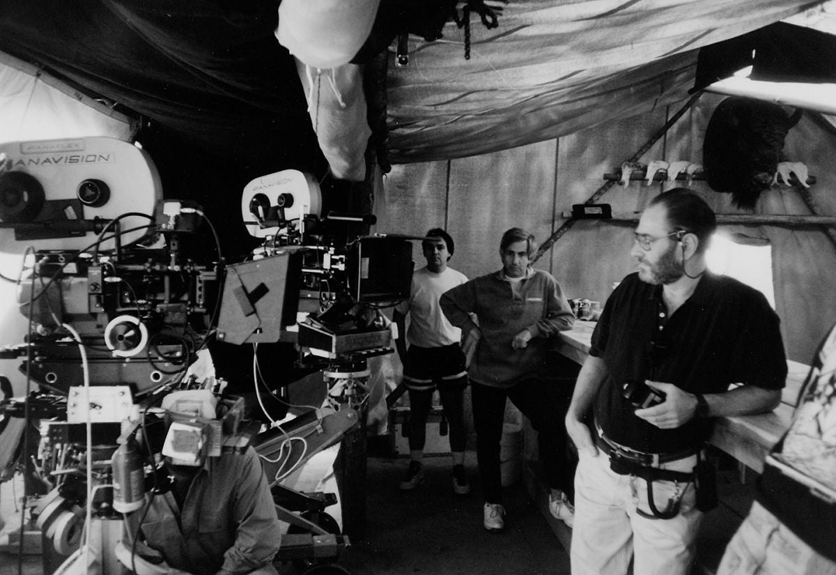 Taking a pause at a saloon bar, Owen Roizman, ASC checks his light while setting up double coverage while shooting Wyatt Earp (1994), for which he earned his fifth Academy Award nomination.