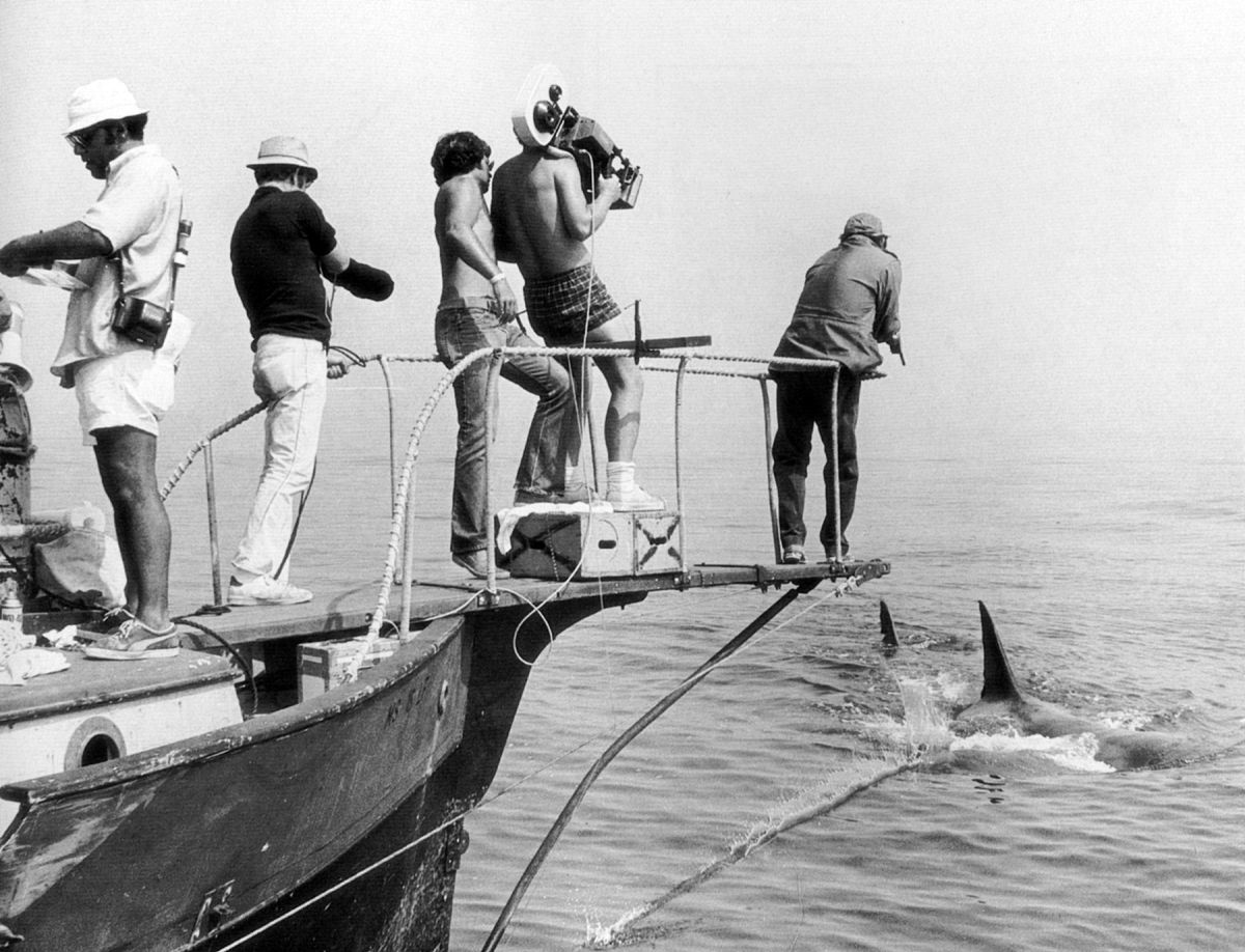 Spielberg watching from over his shoulder, Chapman hefts a Panaflex and angles in past actor Robert Shaw, capturing a memorable shot during the production of Jaws.