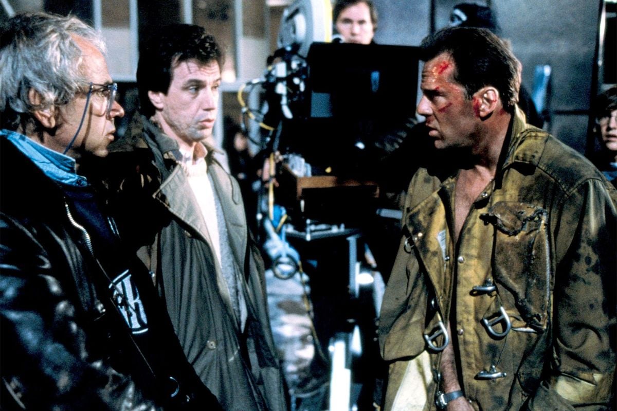 From left, Jan de Bont, ASC, director John McTiernan and Willis confer between shots.